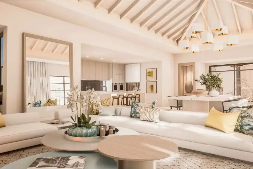 Salón de doble altura con techo inclinado y sofás claros