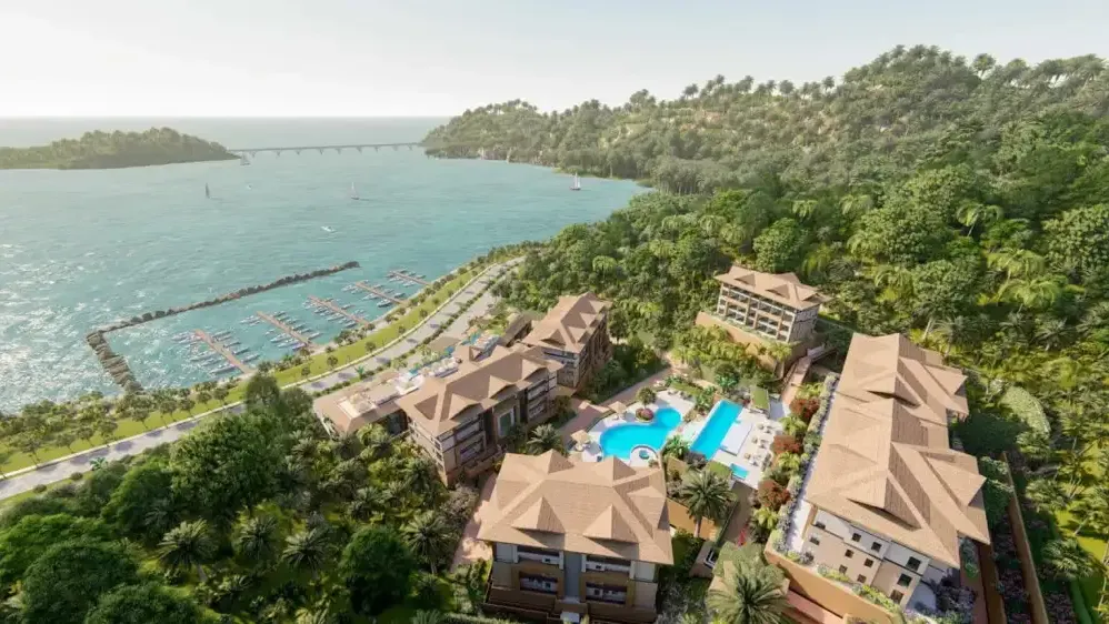 Vista aérea de conjunto residencial costero junto al puerto deportivo